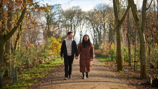 A couple explores the South East Gardens at Seaton Delaval Hall Northumberland